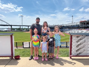 IHMVCU team member and her family at a Quad Cities River Bandits baseball game