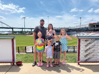 IHMVCU team member and her family at a Quad Cities River Bandits baseball game