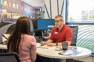 Man and woman sitting in office talking