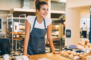 teen girl working first job at bakery counter