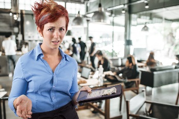 Woman server with tip in one hand and acting upset