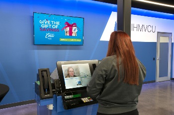 Women talking to ITM agent inside of a branch