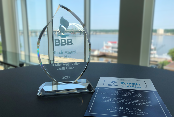 BBB Torch Award in front of window
