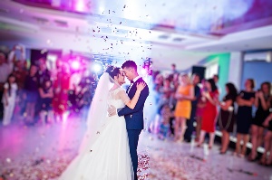 Hispanic couple dancing to their first dance at their wedding