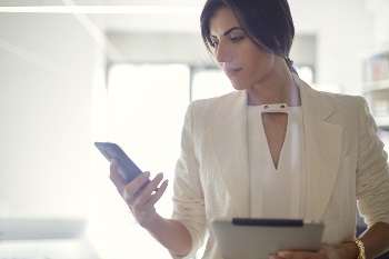 young woman wondering if she should answer phone