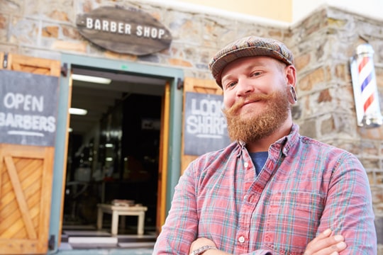 Man in front of Barber Shop