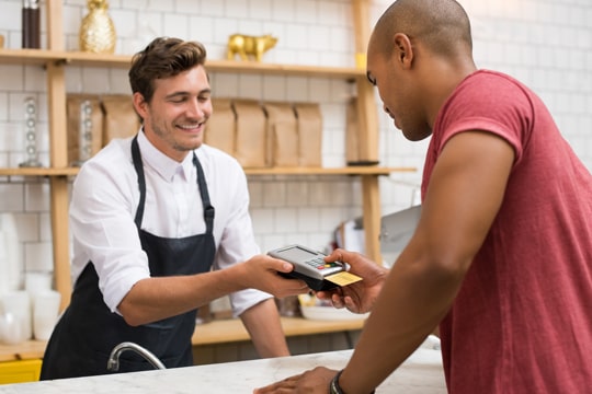 Business owner accepting credit card payments Business owner accepting credit card payments