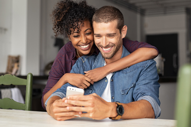 compass-playlists couple looking at a phone excited