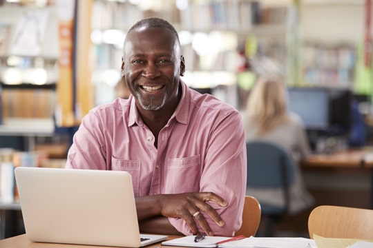 Man on computer looking for life insurance Man on computer looking for life insurance
