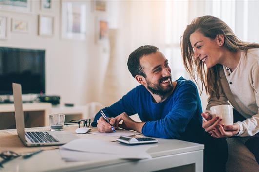 husband and wife checking out finances_small happy couple opening cd online