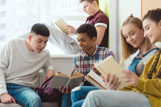 Group of students reading together Group of students reading together