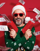 man in christmas sweater with money